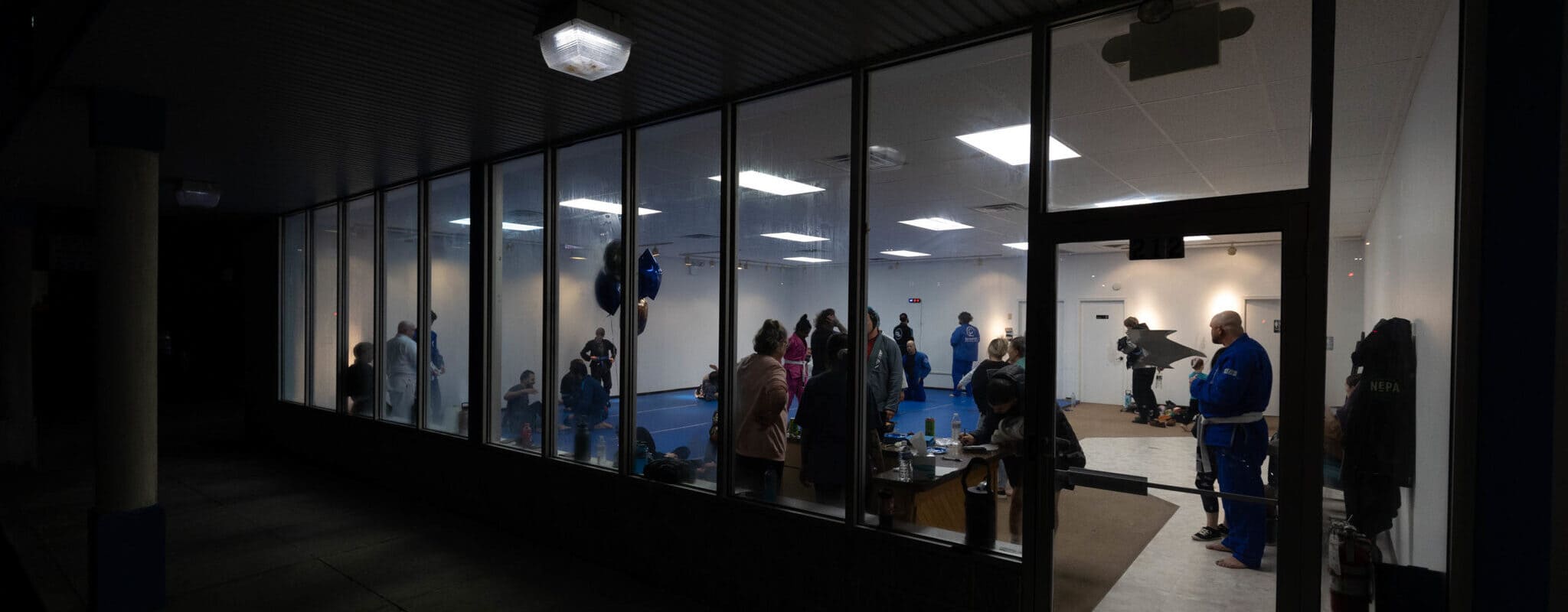 viewed into the training area at wilkes barre mma as classes are going on and spectators watch through the windows