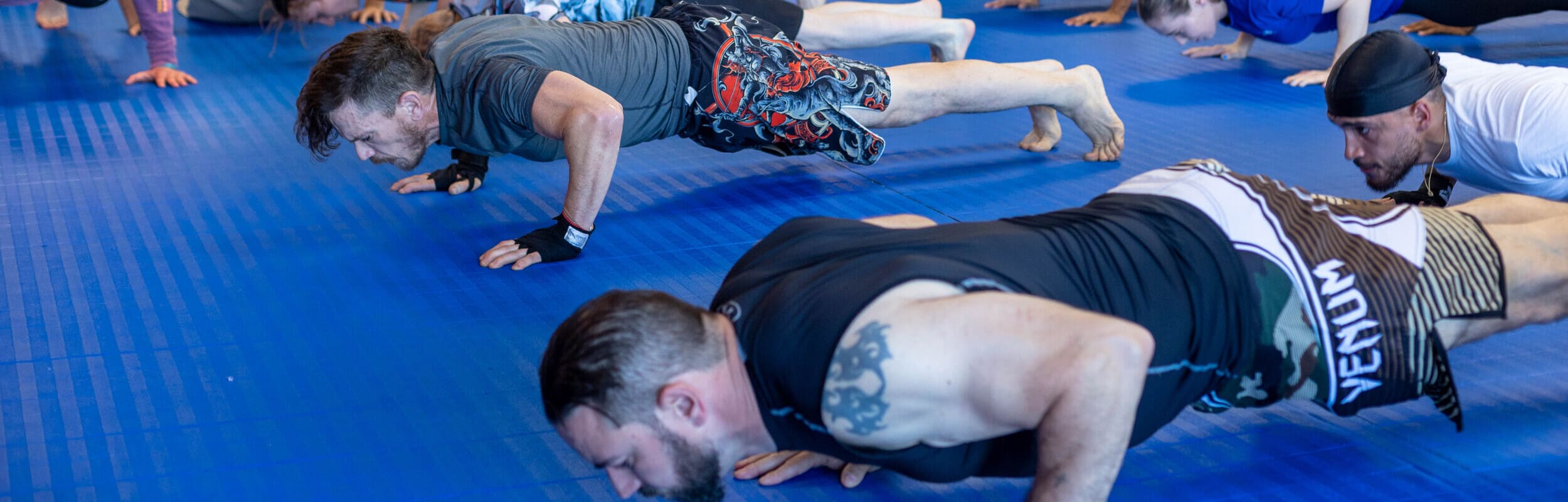 group of jiu jitsu students doing pushups